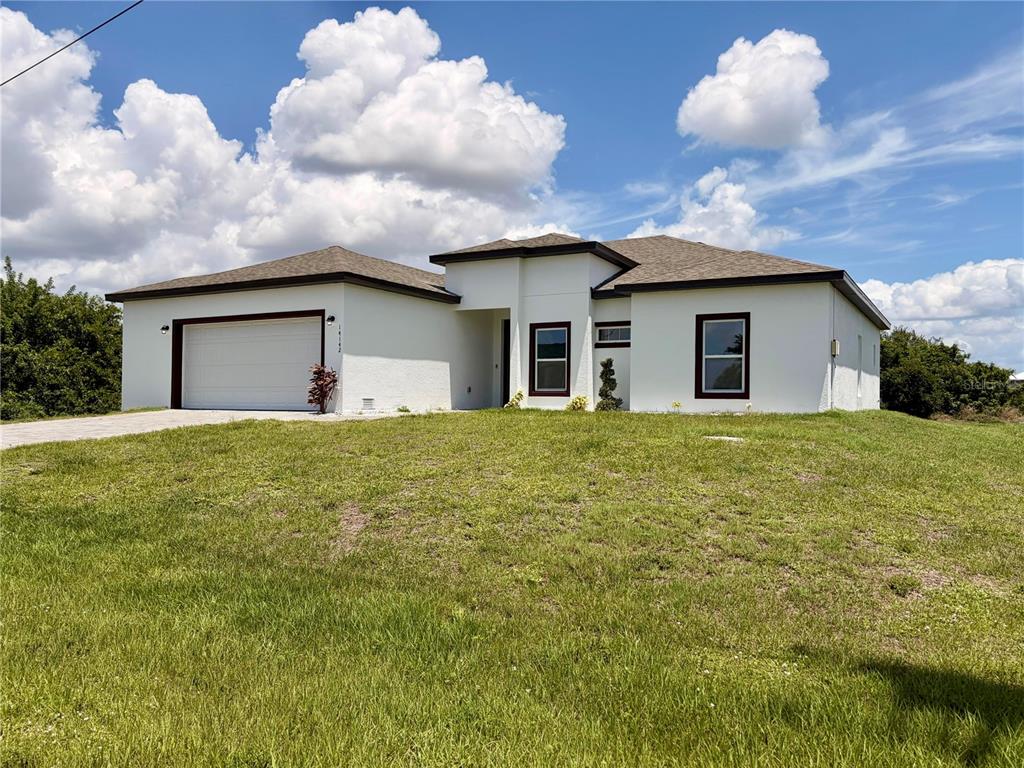 14142 Appleton Boulevard Port Charlotte, FL 33981 - Photo 2 of 26 a white house with a big yard and large trees