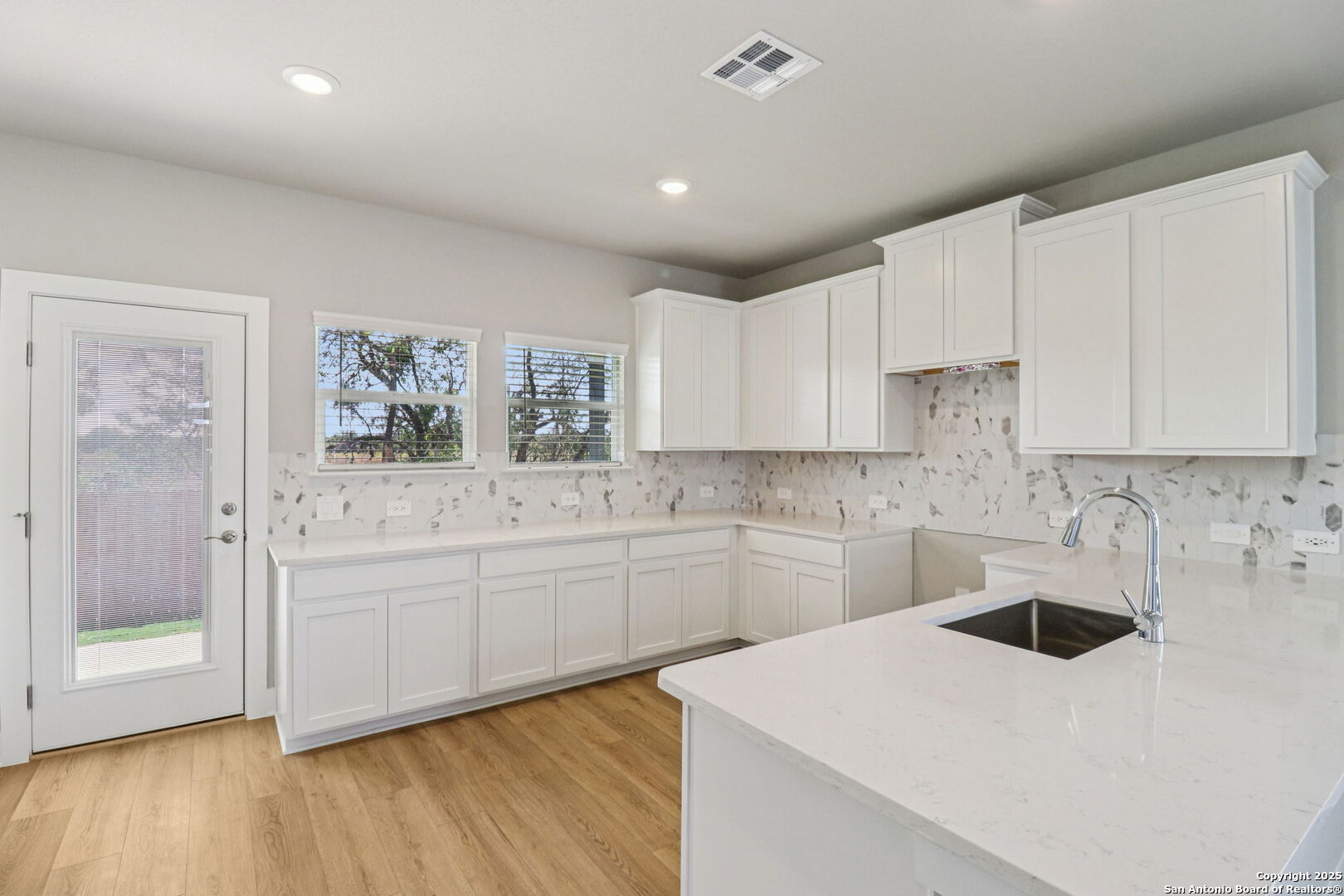12602 Winding Butte Schertz, TX 78154 - Photo 11 of 46 a kitchen with a sink a stove and cabinets
