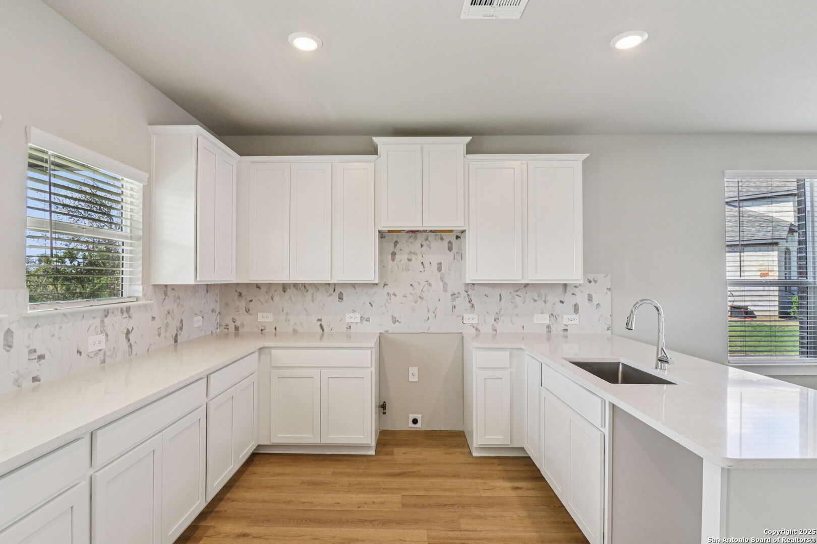 12602 Winding Butte Schertz, TX 78154 - Photo 12 of 46 a kitchen with a sink cabinets and window