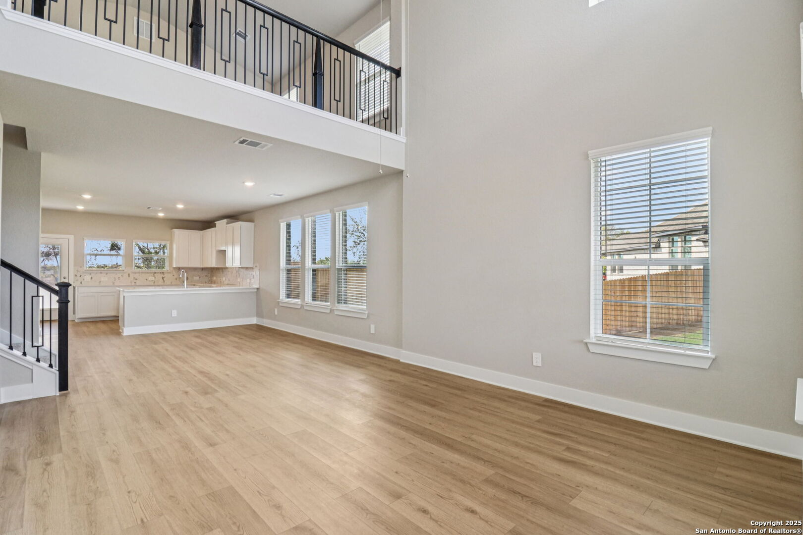 12602 Winding Butte Schertz, TX 78154 - Photo 13 of 46 a view of an empty room with wooden floor and a window
