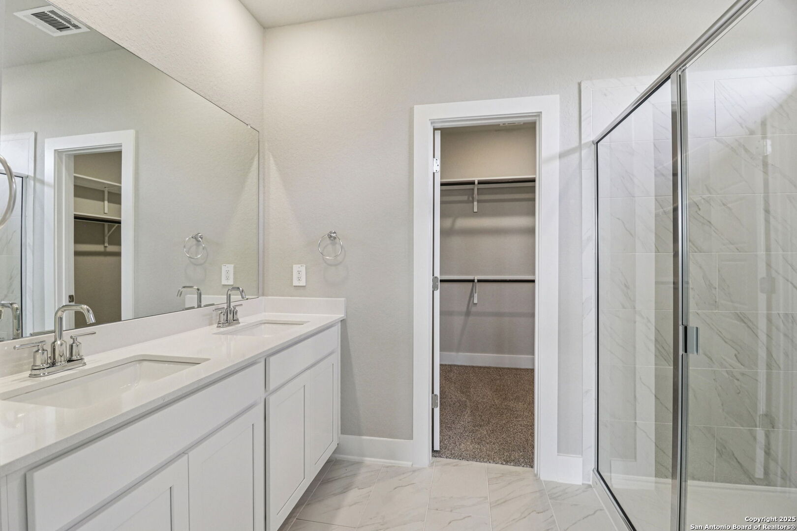 12602 Winding Butte Schertz, TX 78154 - Photo 22 of 46 a bathroom with a double vanity sink and mirror