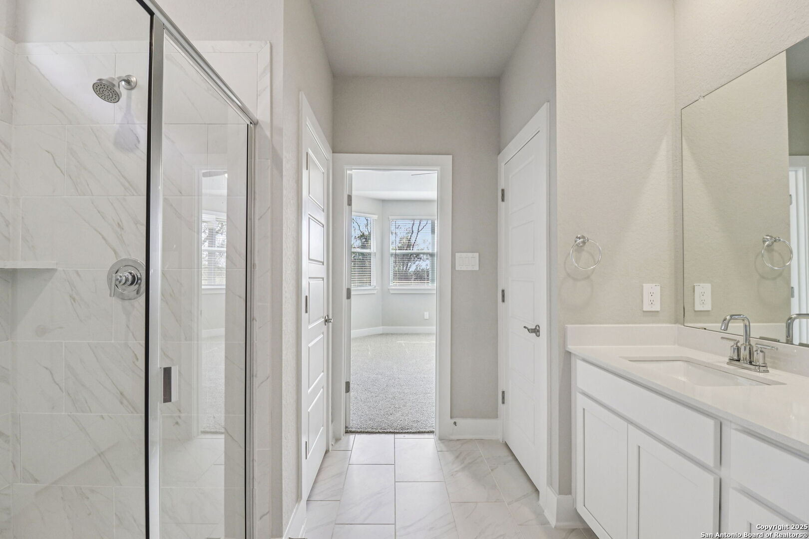 12602 Winding Butte Schertz, TX 78154 - Photo 23 of 46 a bathroom with a granite countertop sink a mirror and a shower