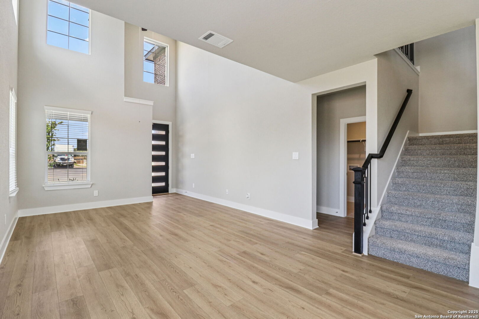 12602 Winding Butte Schertz, TX 78154 - Photo 7 of 46 a view of an empty room with wooden floor and stairs