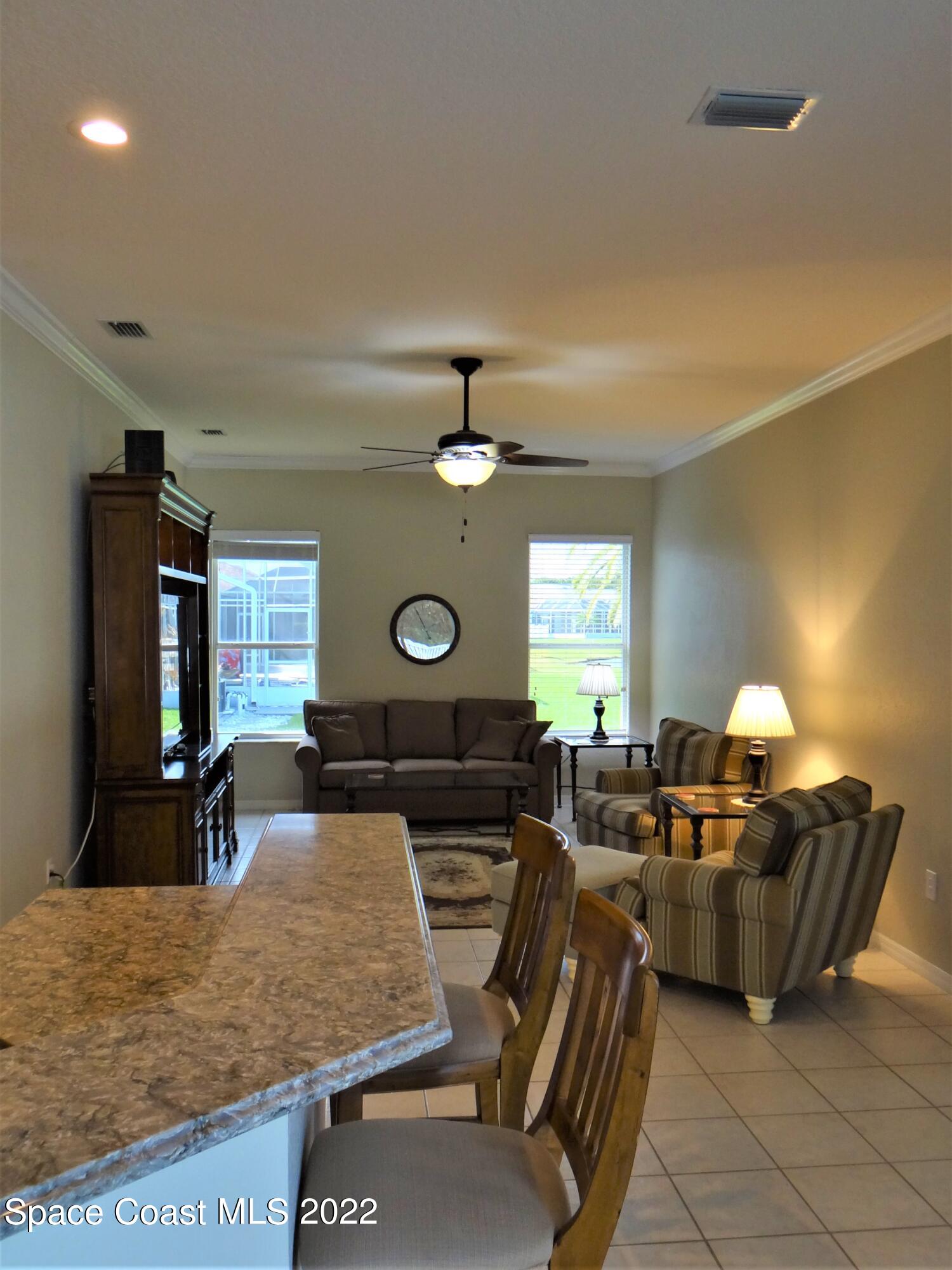 3100 Huntleigh Way Melbourne, FL 32934 - Photo 16 of 54 a living room with furniture and a flat screen tv