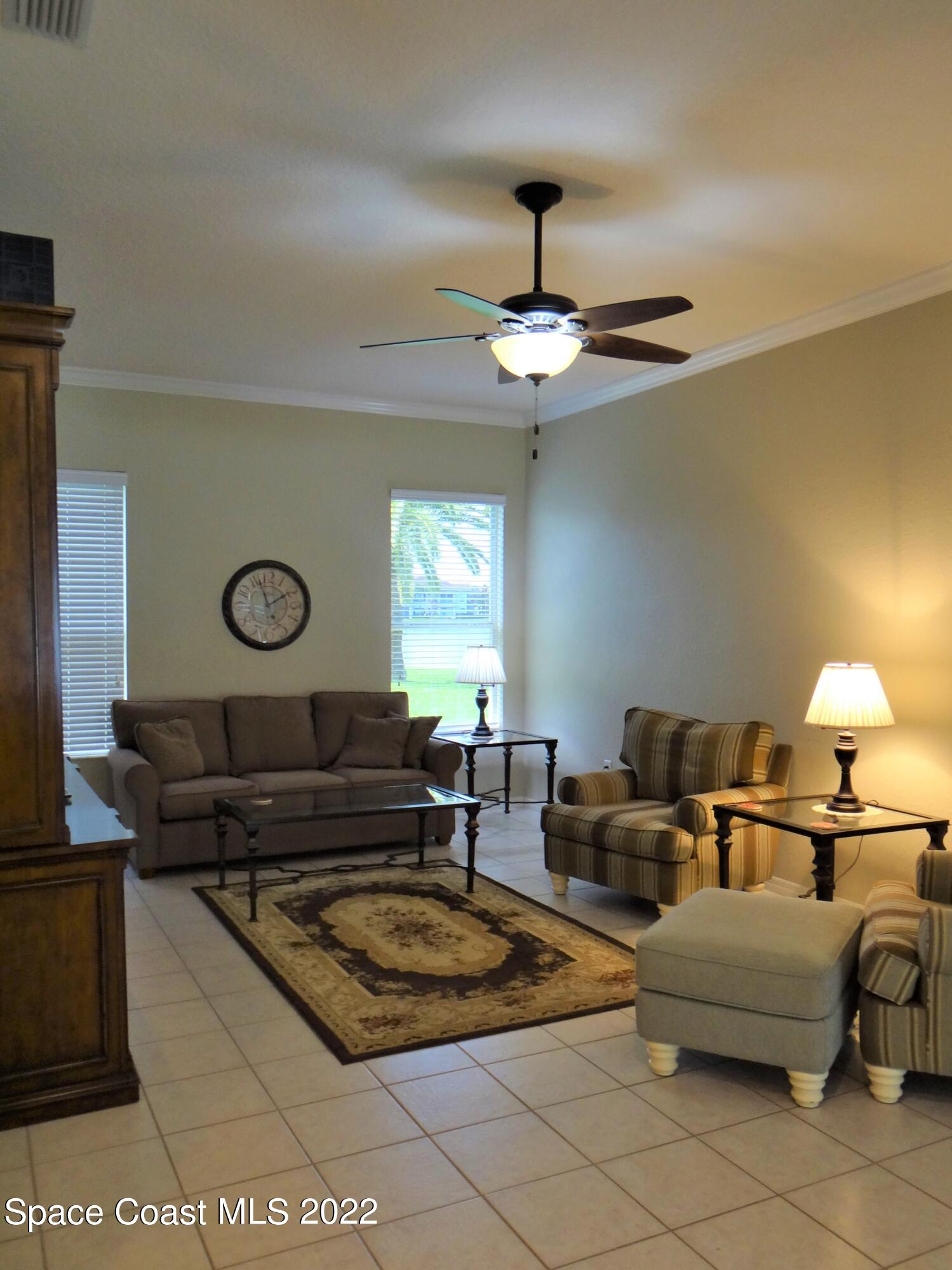 3100 Huntleigh Way Melbourne, FL 32934 - Photo 17 of 54 a living room with furniture a lamp and a window
