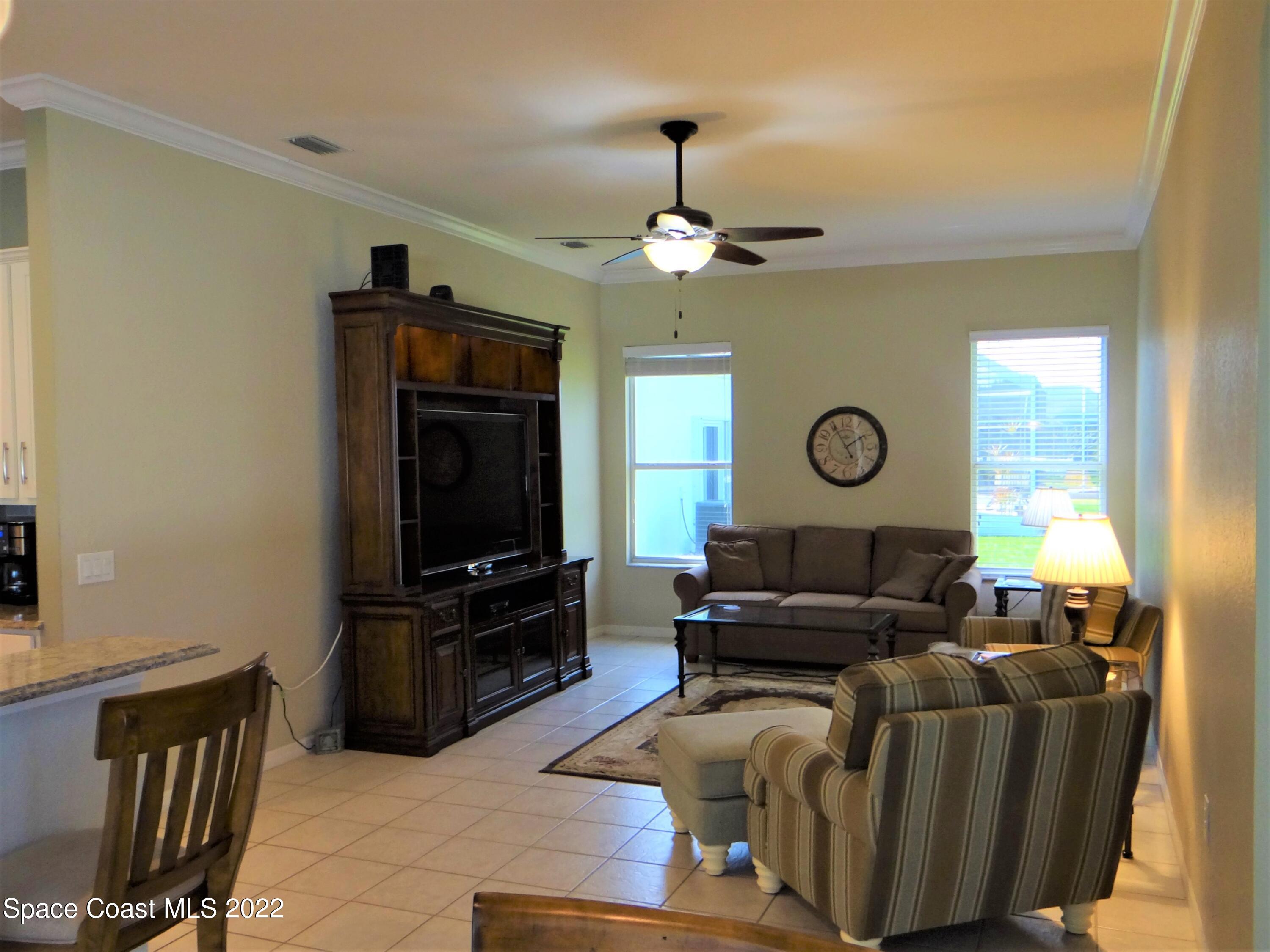 3100 Huntleigh Way Melbourne, FL 32934 - Photo 18 of 54 a living room with furniture and a flat screen tv