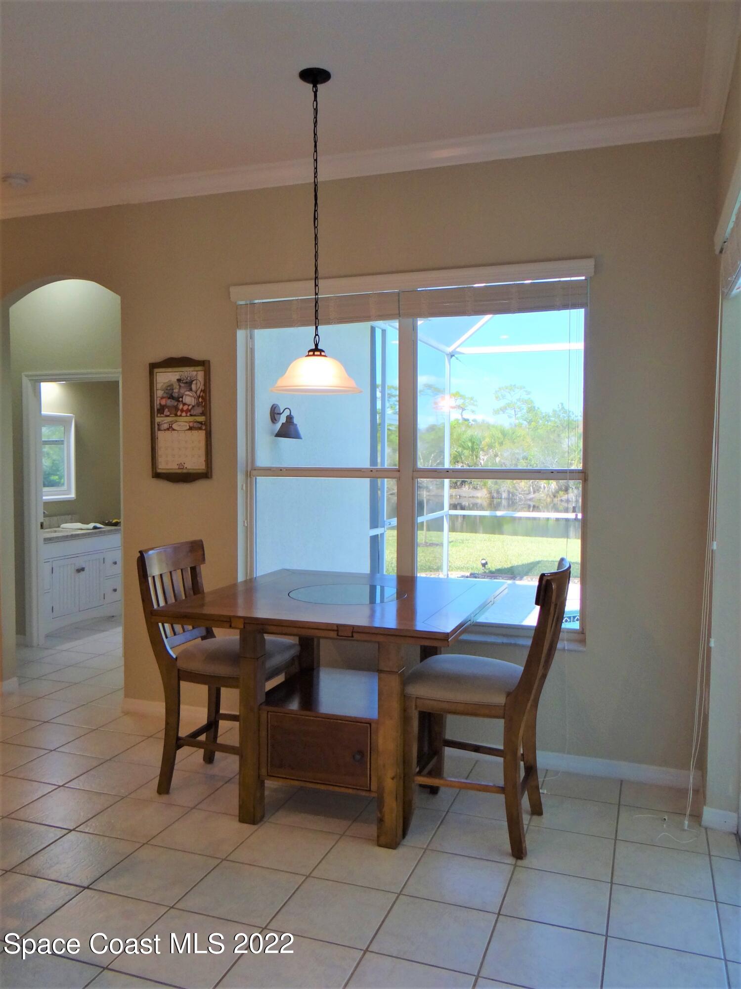 3100 Huntleigh Way Melbourne, FL 32934 - Photo 19 of 54 a dining room with furniture and window