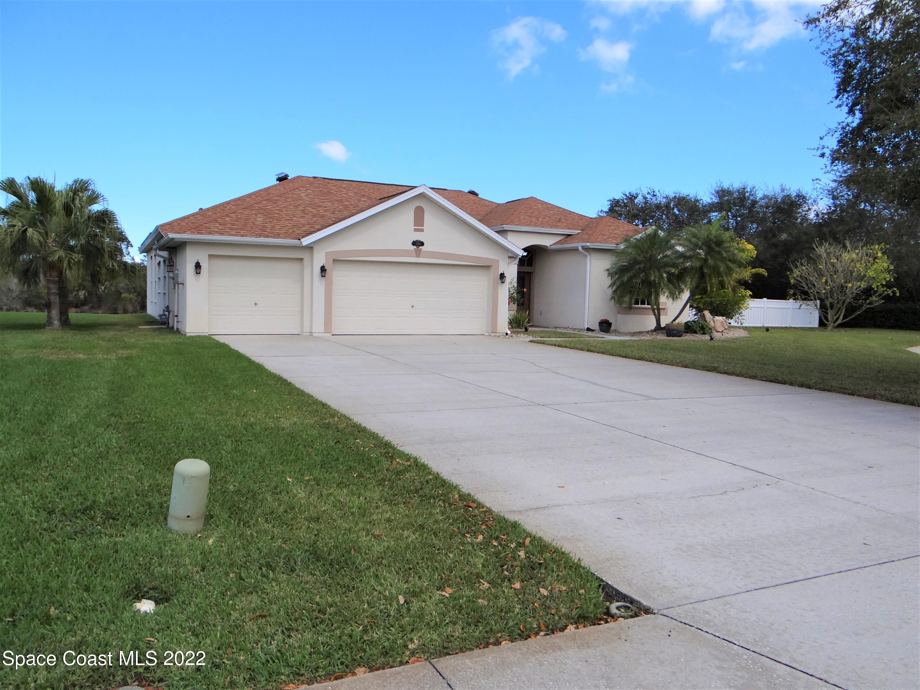 3100 Huntleigh Way Melbourne, FL 32934 - Photo 2 of 54 a view of a house with a yard