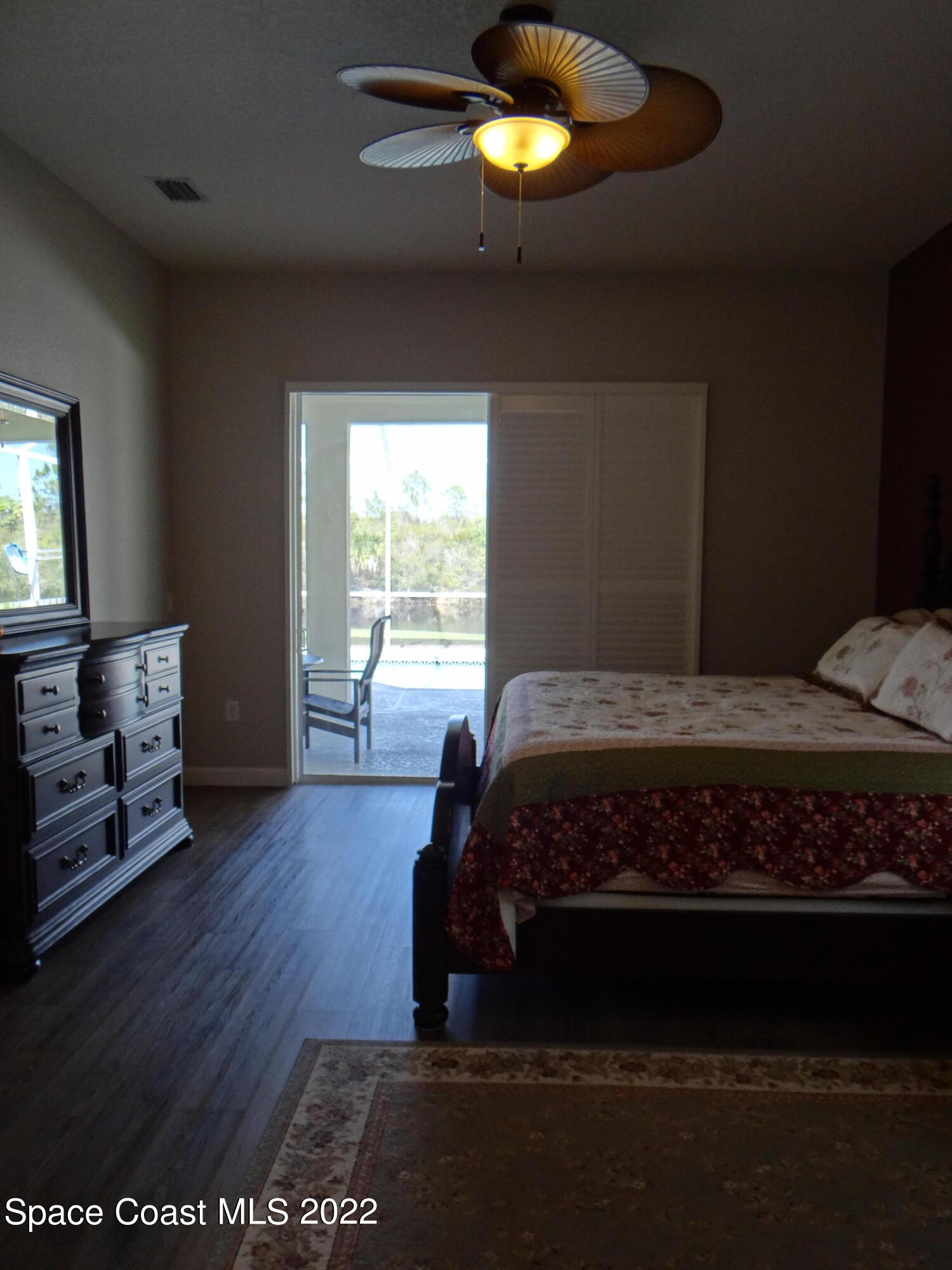 3100 Huntleigh Way Melbourne, FL 32934 - Photo 24 of 54 a bedroom with a bed and a large window