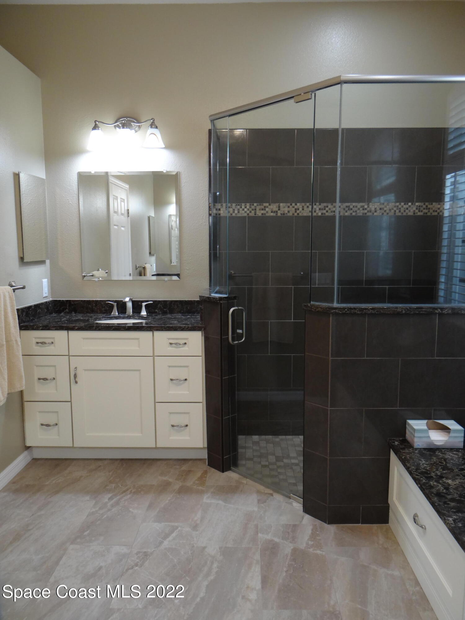3100 Huntleigh Way Melbourne, FL 32934 - Photo 25 of 54 a bathroom with a granite countertop sink a toilet and shower