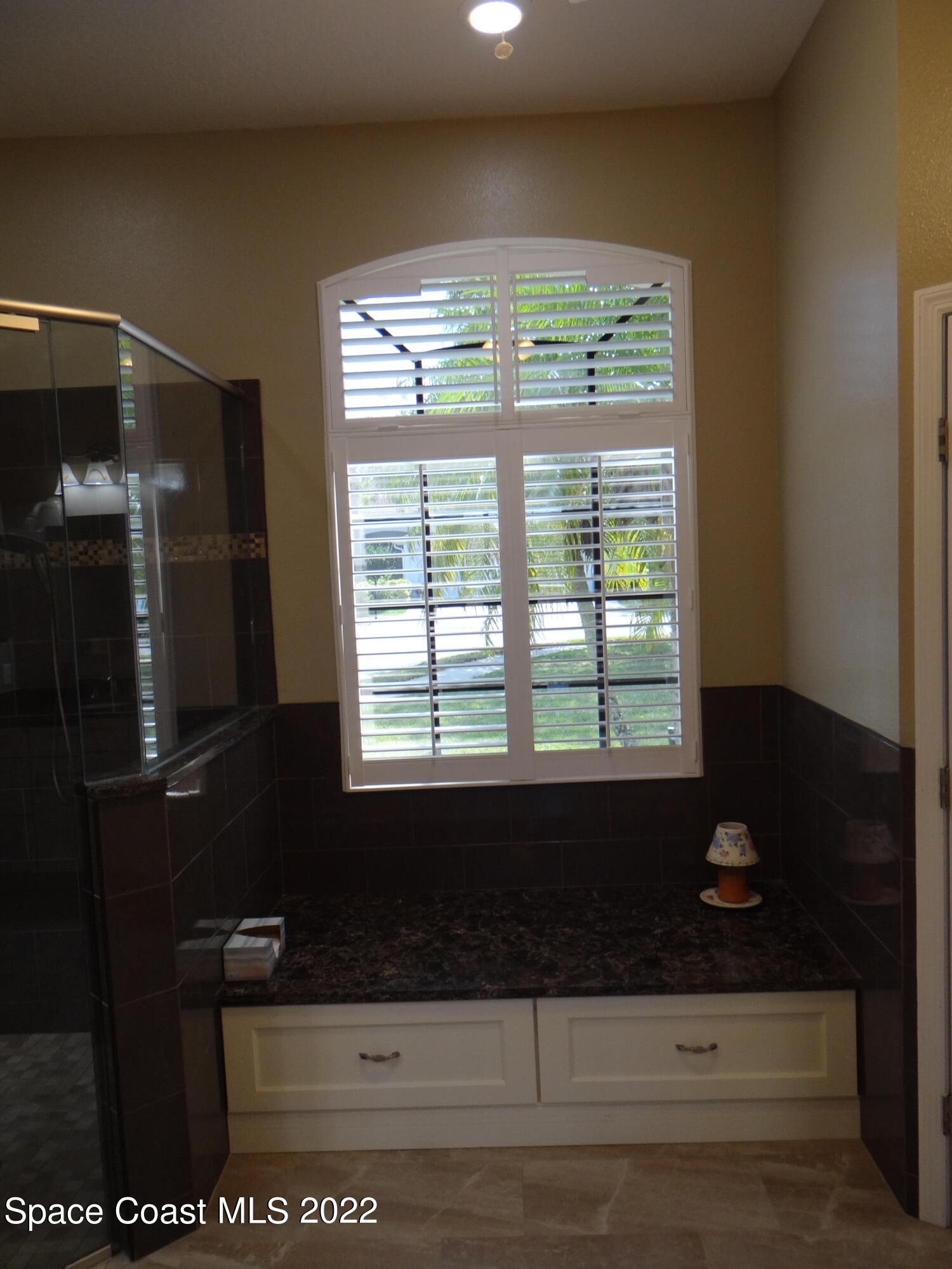3100 Huntleigh Way Melbourne, FL 32934 - Photo 26 of 54 a bathroom with a bathtub and shower