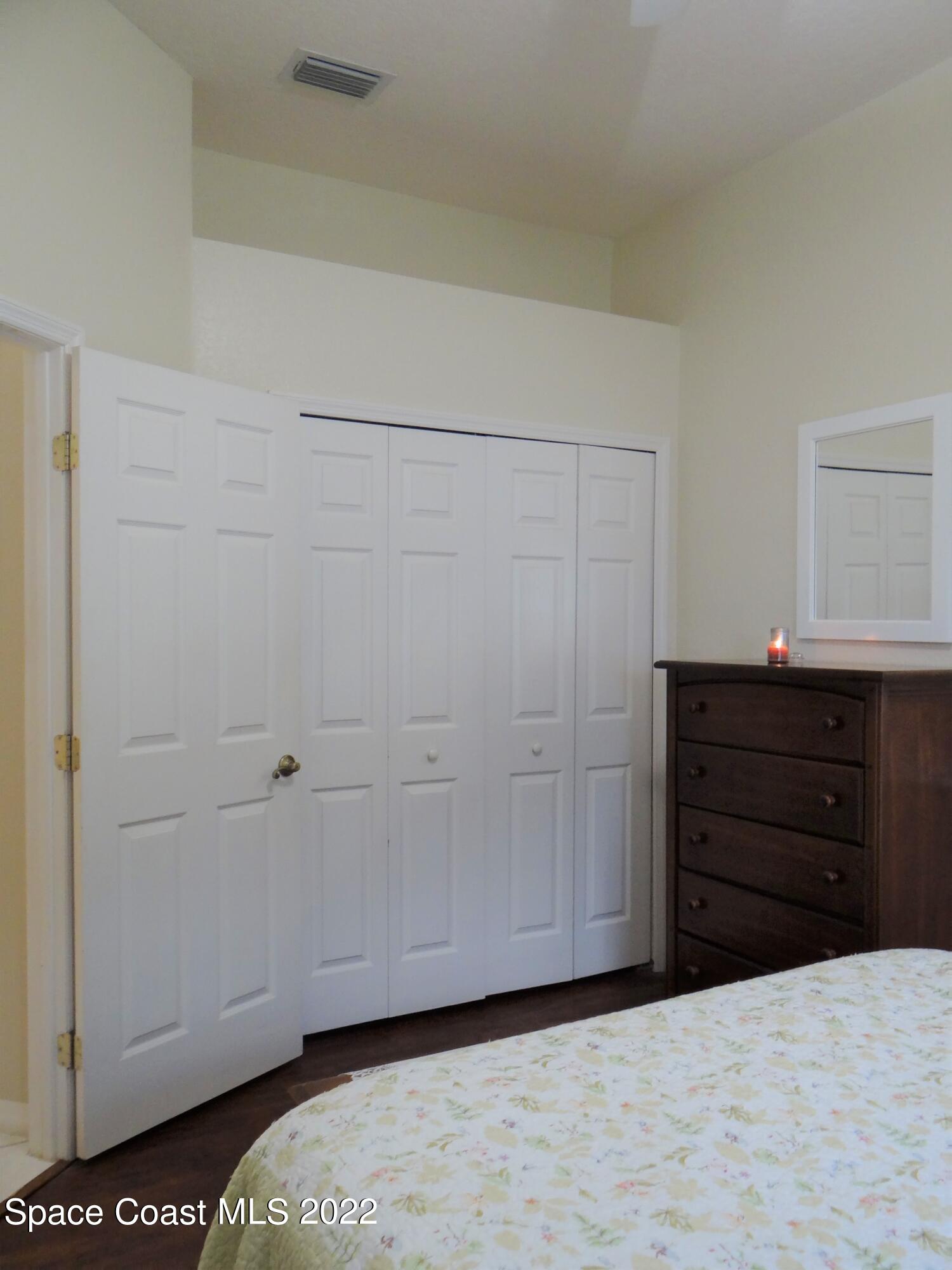 3100 Huntleigh Way Melbourne, FL 32934 - Photo 32 of 54 a room with a dresser and a mirror