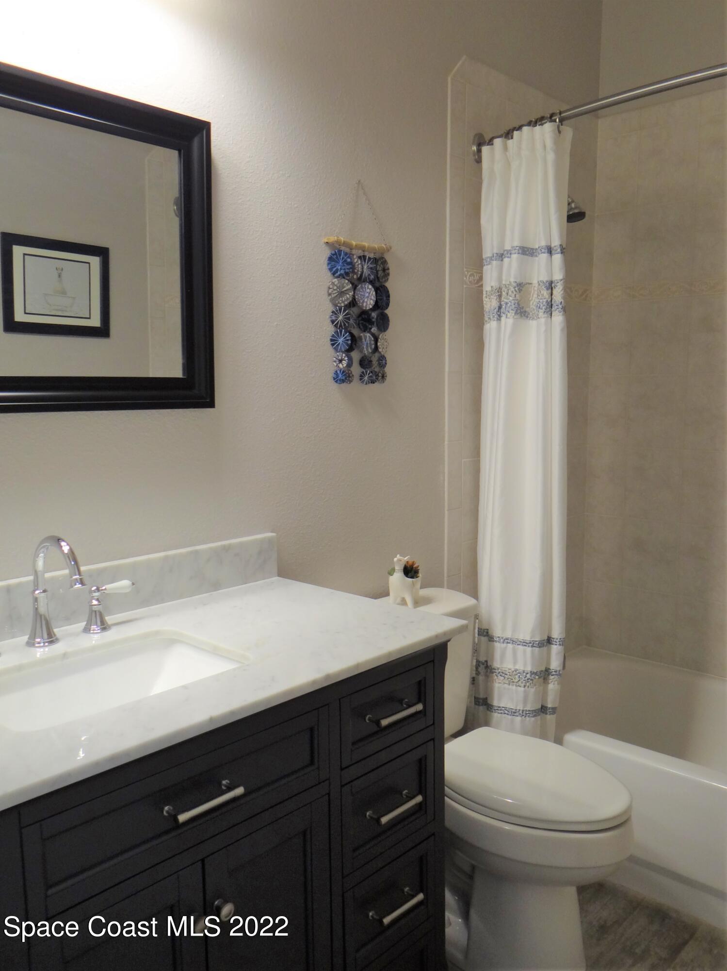 3100 Huntleigh Way Melbourne, FL 32934 - Photo 33 of 54 a bathroom with a sink a toilet and shower