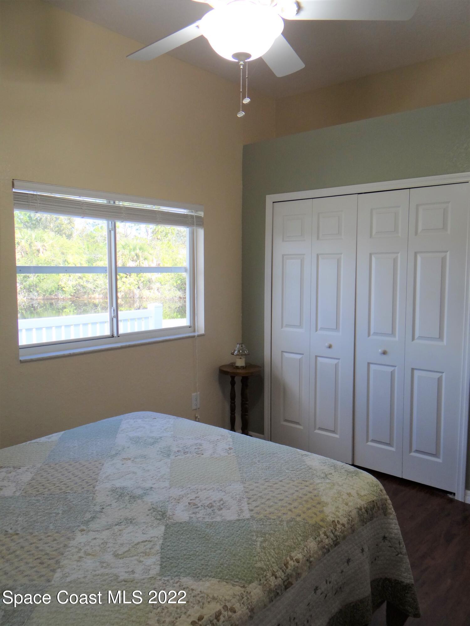 3100 Huntleigh Way Melbourne, FL 32934 - Photo 36 of 54 a bedroom with a bed and a window