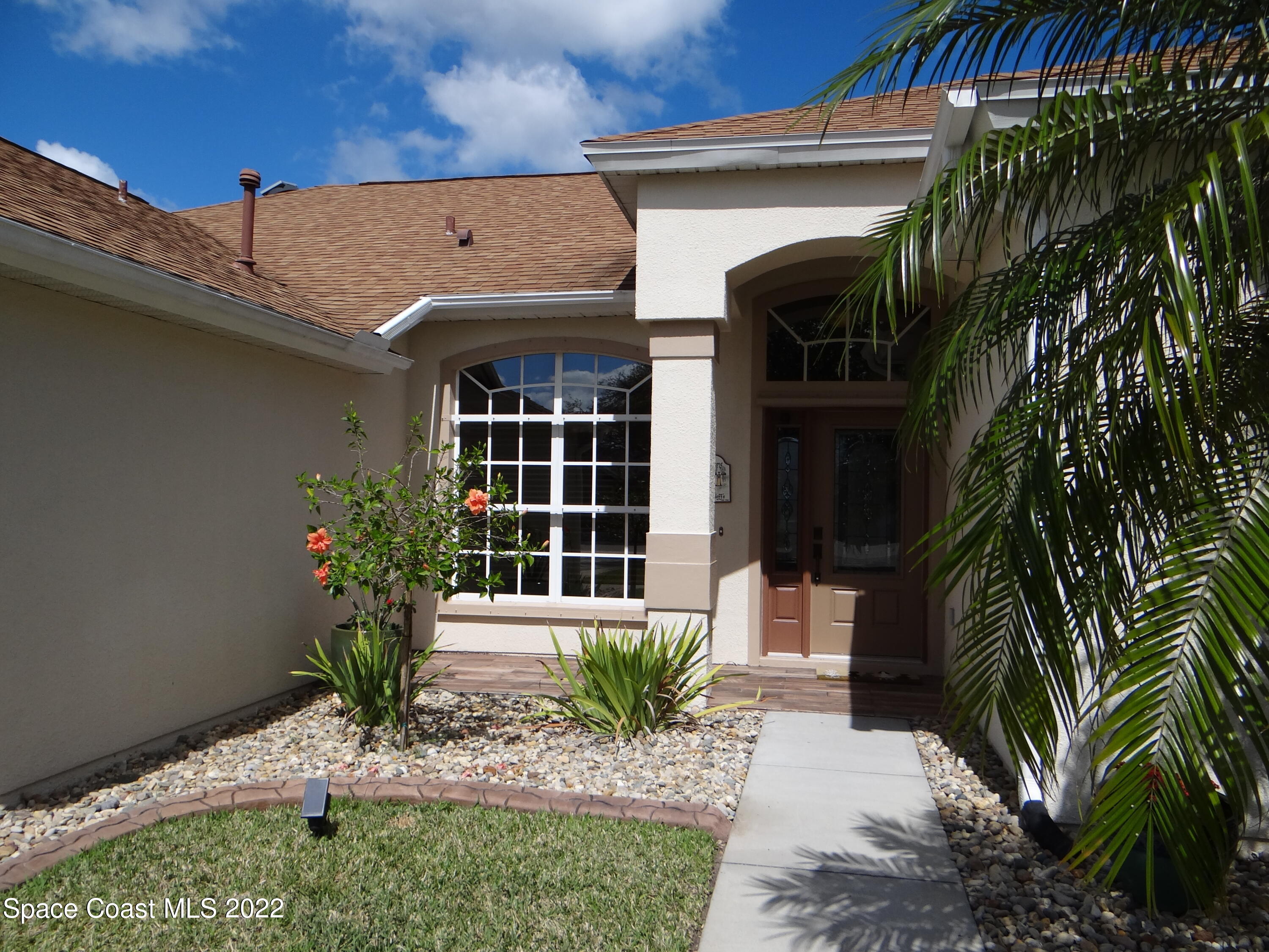 3100 Huntleigh Way Melbourne, FL 32934 - Photo 4 of 54 a front view of a house with a yard