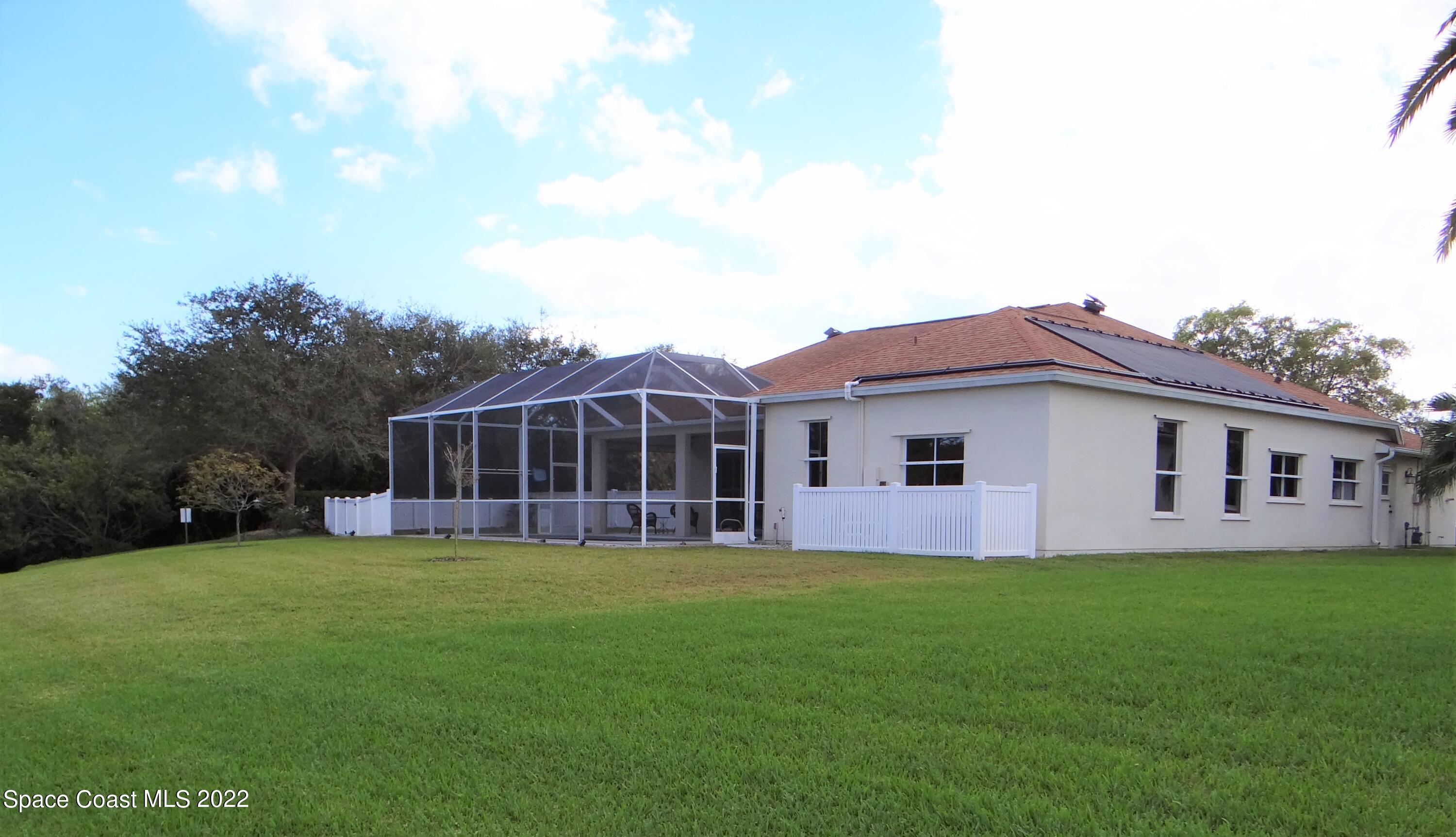 3100 Huntleigh Way Melbourne, FL 32934 - Photo 51 of 54 a view of a house with a yard and sitting area