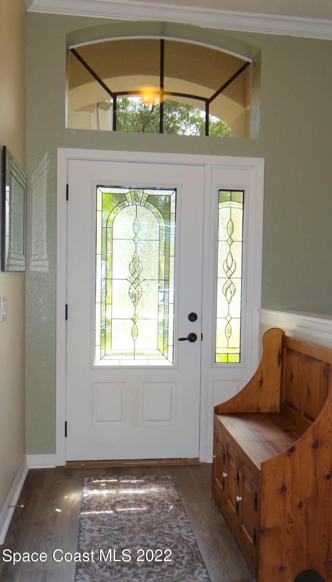 3100 Huntleigh Way Melbourne, FL 32934 - Photo 6 of 54 a bedroom with a bed and a window