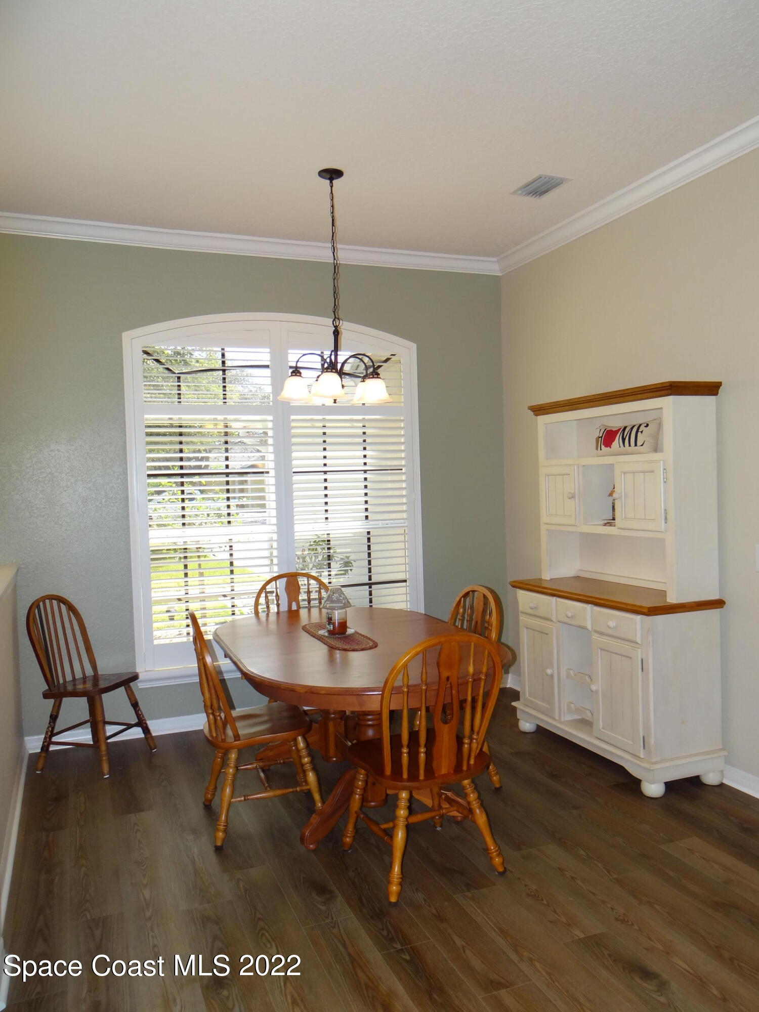 3100 Huntleigh Way Melbourne, FL 32934 - Photo 8 of 54 a view of a dining room with furniture window and wooden floor
