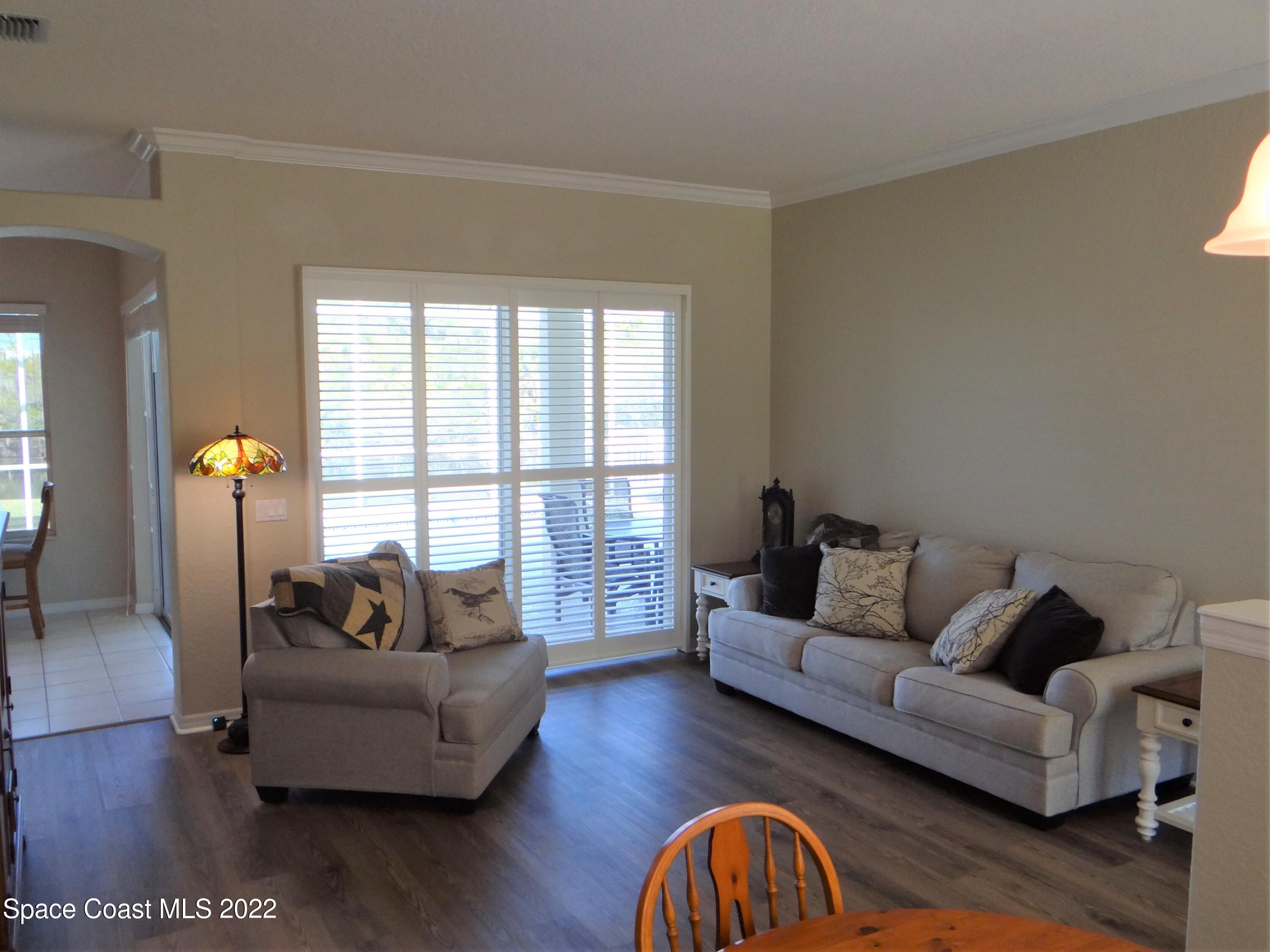 3100 Huntleigh Way Melbourne, FL 32934 - Photo 9 of 54 a living room with furniture and a large window