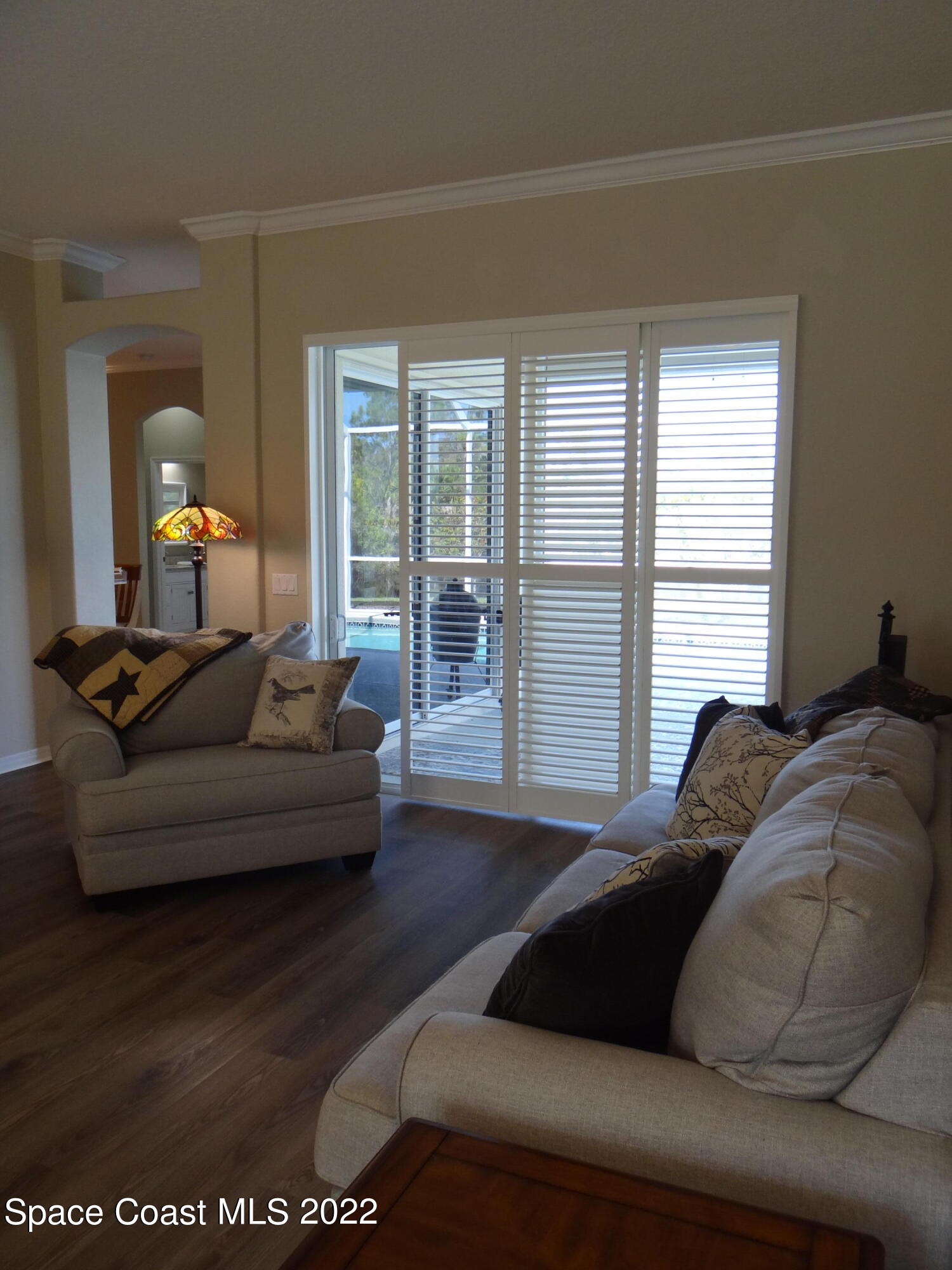 3100 Huntleigh Way Melbourne, FL 32934 - Photo 10 of 54 a living room with furniture and a large window