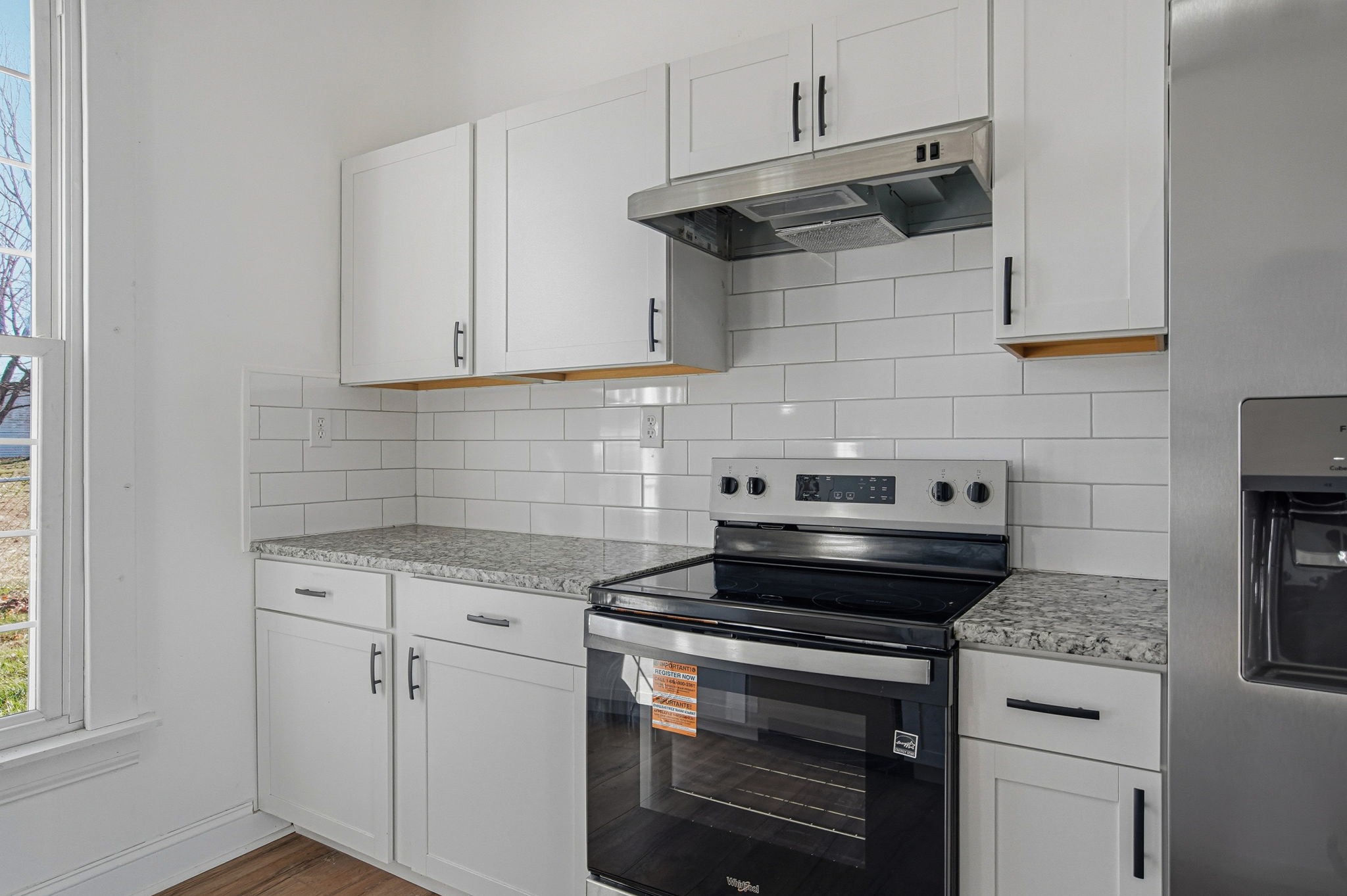 204 Winters Street Adams, TN 37010 - Photo 15 of 18 a kitchen with stainless steel appliances granite countertop white cabinets and a stove