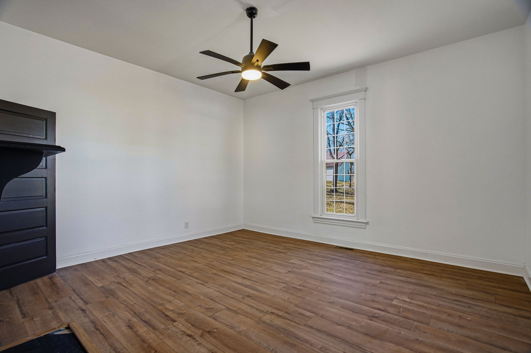 204 Winters Street Adams, TN 37010 - Photo 5 of 18 a view of empty room with wooden floor and fan