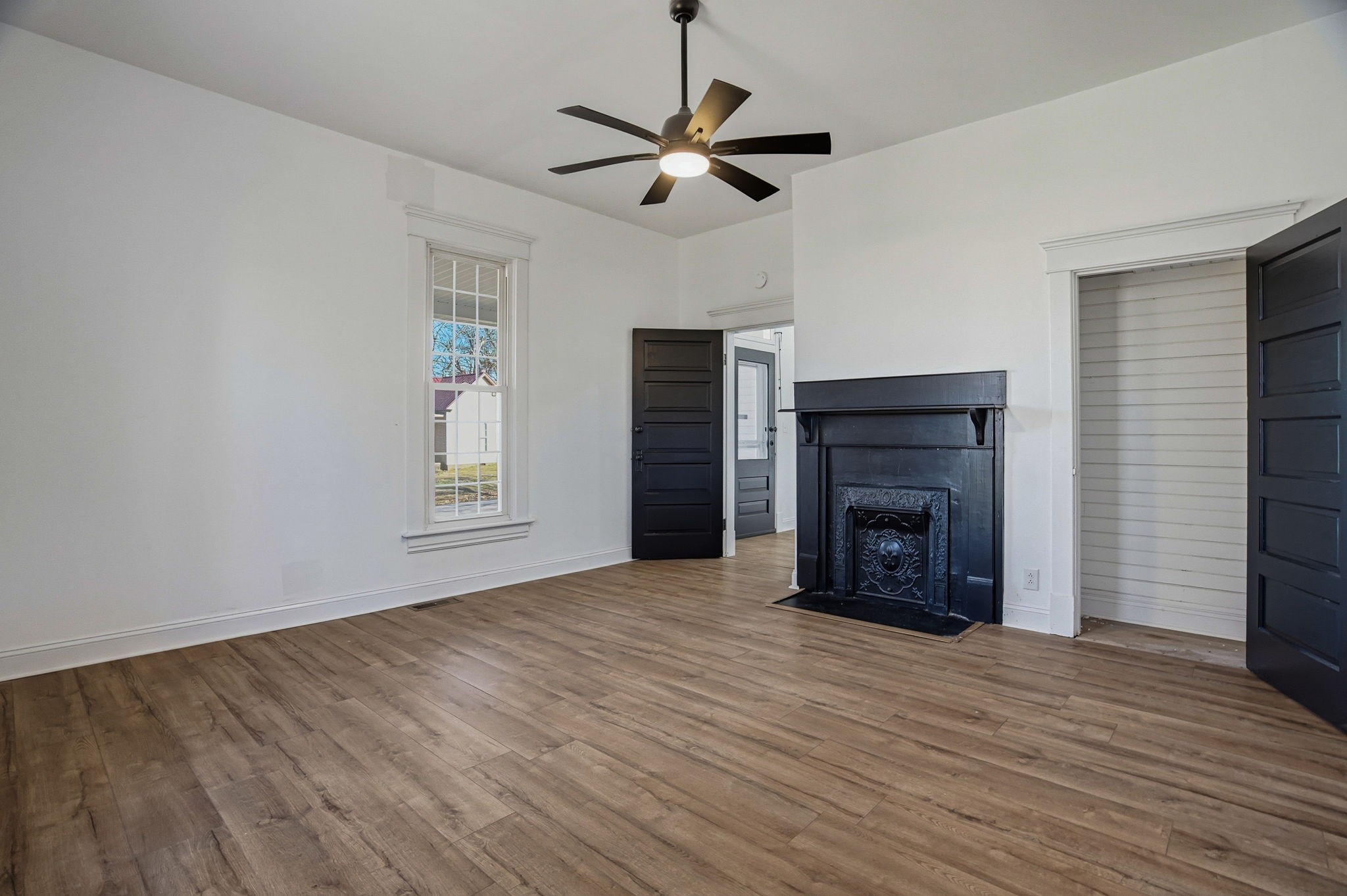 204 Winters Street Adams, TN 37010 - Photo 6 of 18 a view of an empty room with a fireplace and a window