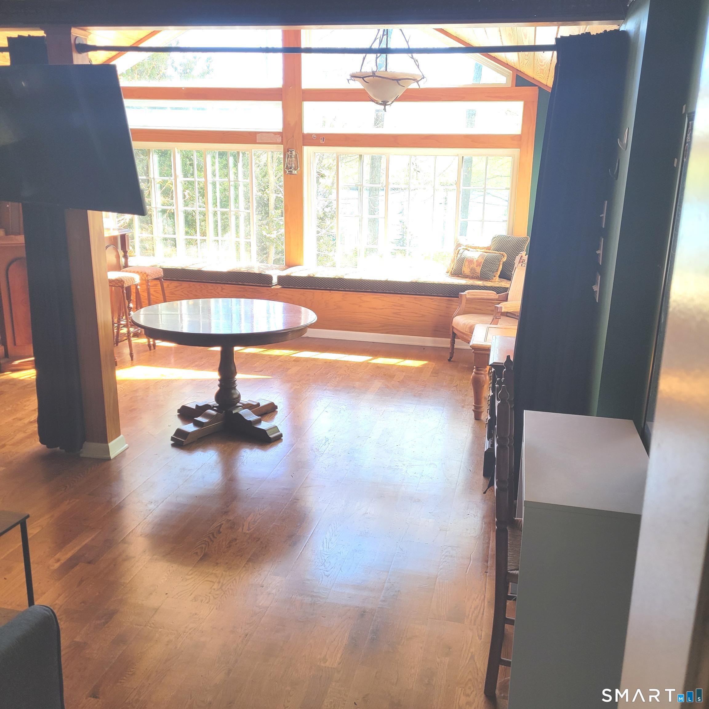 22 Ridgewood Road East Haddam, CT 06415 - Photo 11 of 28 The great room features a wood cathedral ceiling, French doors to the deck and a wall of windows with a custom built in storage bench on the lakeside