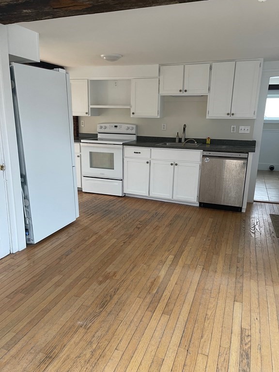 38 Heywood Road Ashby, MA 01431 - Photo 2 of 12 a kitchen with granite countertop a stove a sink and a refrigerator