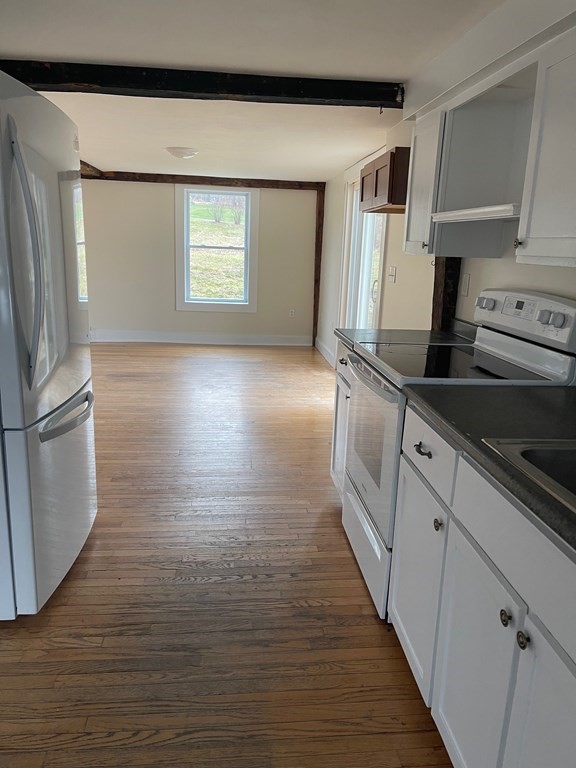 38 Heywood Road Ashby, MA 01431 - Photo 3 of 12 a kitchen with stainless steel appliances granite countertop a sink and a stove