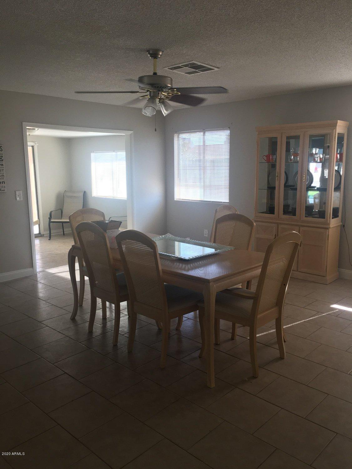 7401 West Hatcher Road Peoria, AZ 85345 - Photo 3 of 5 a view of a dining room with furniture and window