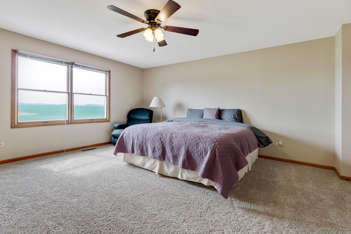 753 Millview Drive Batavia, IL 60510 - Photo 16 of 30 a spacious bedroom with a bed and a ceiling fan