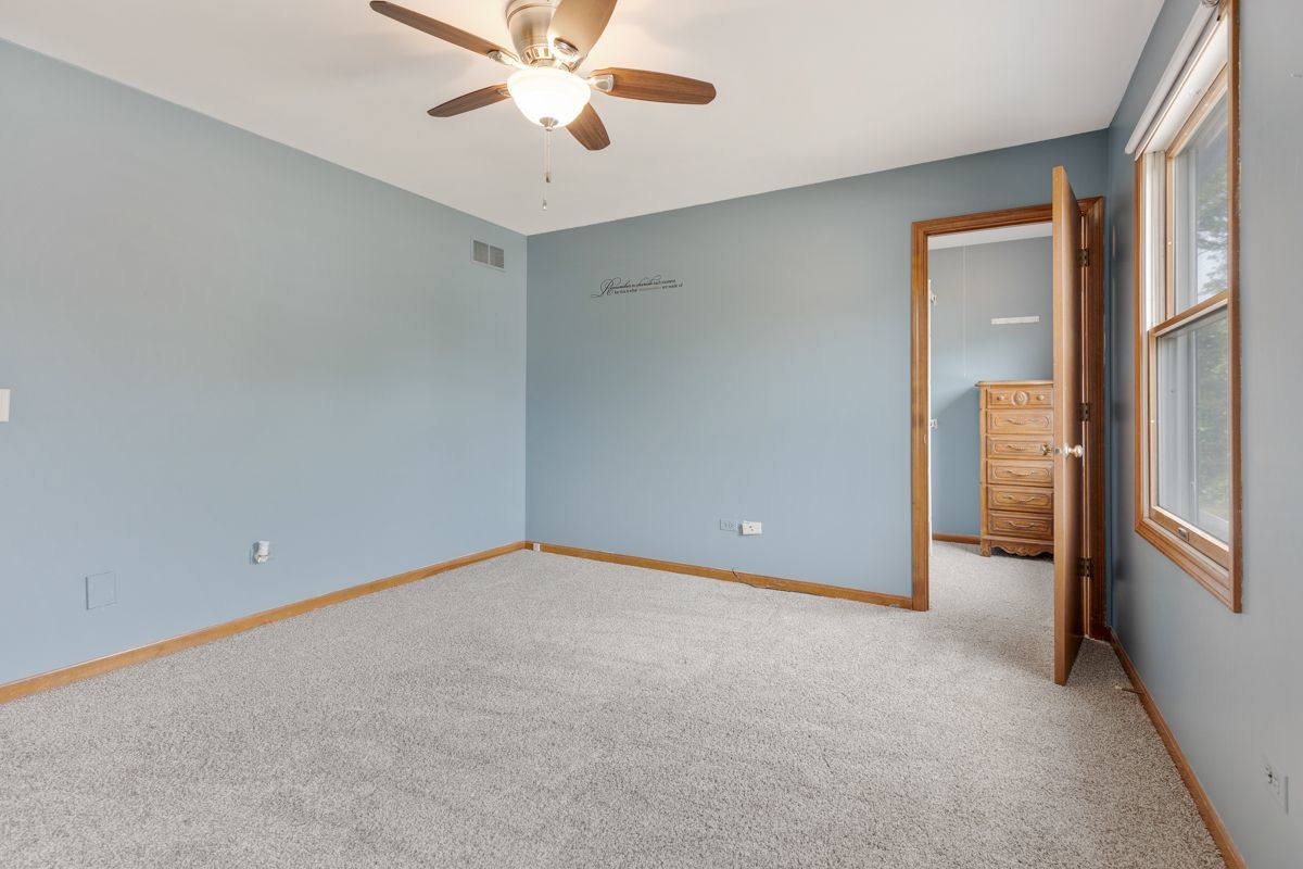 753 Millview Drive Batavia, IL 60510 - Photo 20 of 30 an empty room with a ceiling fan and window