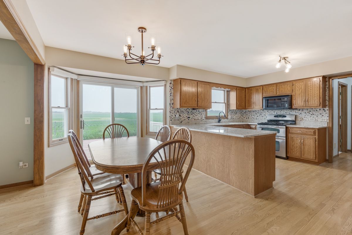 753 Millview Drive Batavia, IL 60510 - Photo 8 of 30 a kitchen with stainless steel appliances granite countertop a stove a refrigerator a sink dishwasher a dining table and chairs with wooden floor