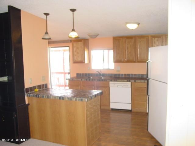 5201 North Lak A Yucca Road Tucson, AZ 85743 - Photo 15 of 19 a kitchen with kitchen island granite countertop white cabinets and window