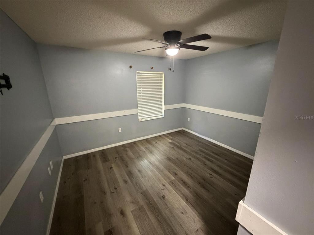 9816 East Granada Court Inverness, FL 34450 - Photo 18 of 28 an empty room with wooden floor and windows