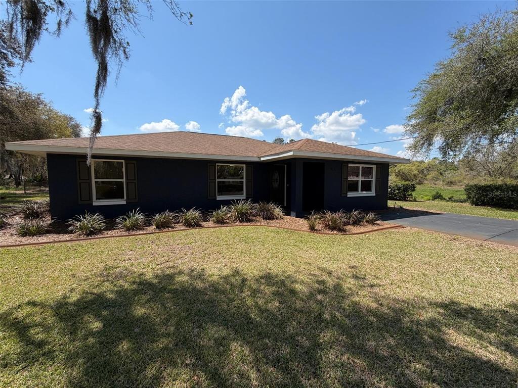 9816 East Granada Court Inverness, FL 34450 - Photo 4 of 28 a front view of a house with a yard and garage