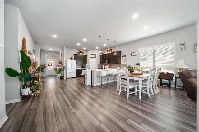 a view of a dining room with furniture window and wooden floor