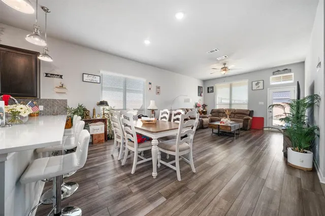 a living room with furniture dining room and wooden floor