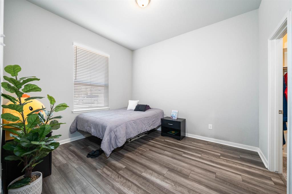 3409 Beutel Road Lorena, TX 76655 - Photo 17 of 32 a bedroom with a bed table and a window