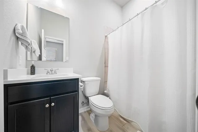 a bathroom with a sink a toilet and a mirror