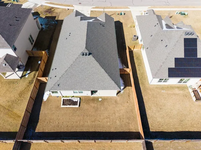 an aerial view of a house with a ocean view