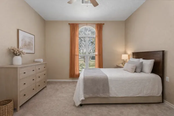 a bedroom with a bed and window