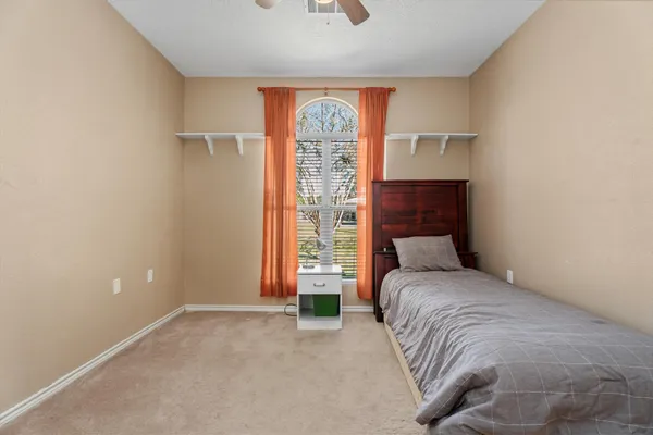 a bedroom with a bed and a window