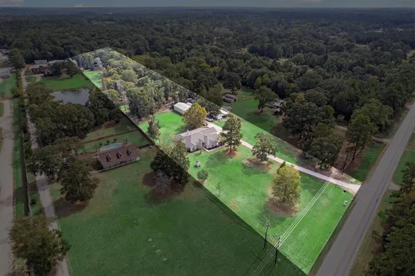 an aerial view of a house with a yard