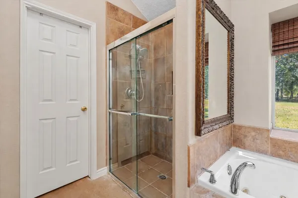 a bathroom with a tub and shower