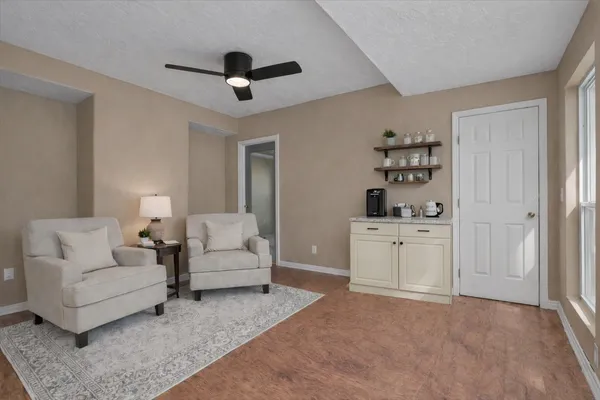a living room with furniture and white walls