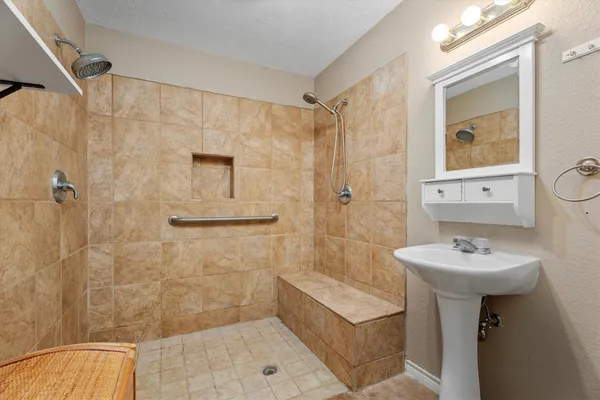 a bathroom with a sink mirror toilet and shower