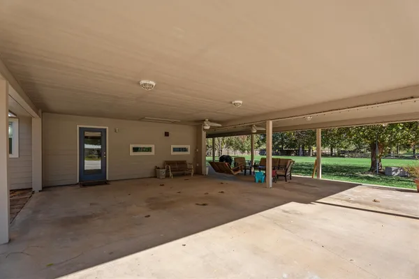 a view of a room with gym equipment and large tree