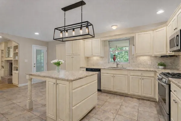 a kitchen with stainless steel appliances granite countertop a sink and stove